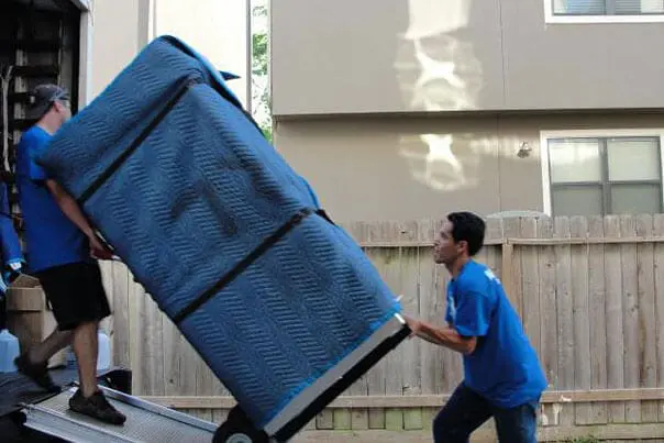 Furniture removalists loading client furniture with care